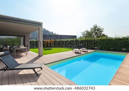 modern house with pool, loungers sun by the pool