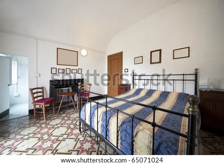 bedroom with double bed in wrought iron of decadent old pension
