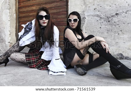 modern punk fashion, portrait of two models posing dressed In vintage clothes