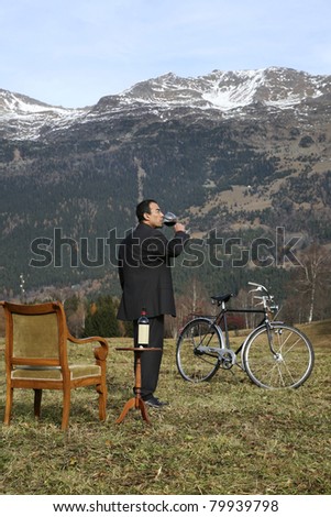 adult man red wine savors outdoors in the mountains