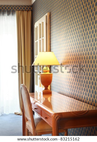 interior luxury apartment, detail room, table lamp and wooden desk