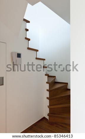 Modern apartment, entrance and wooden staircase