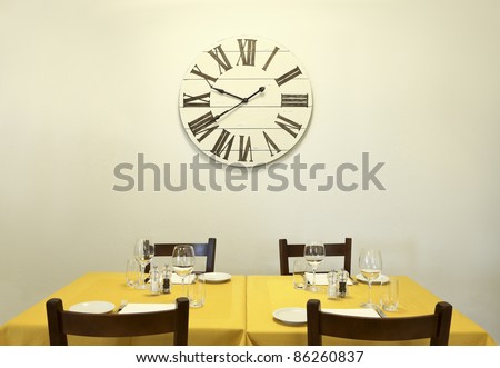 dining table and clock on the wall