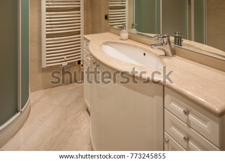 Marble bathroom and large mirror. Nobody inside