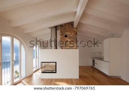 Modern renovated apartment with a large fireplace in the middle of the room which makes the ambieme more comforting