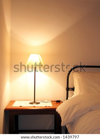 Portrait photo of farm house bed and lamp.