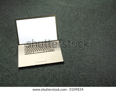 Landscape photo of a laptop on a carpeted office floor
