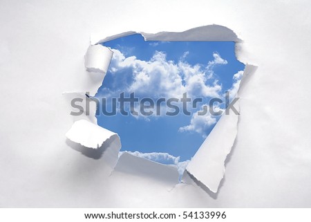 Paper ripped to reveal blue sky.