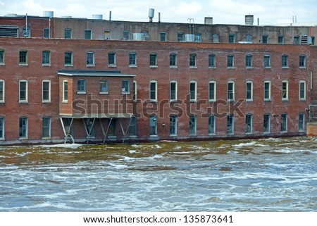 Abandoned factory in rising flood waters
