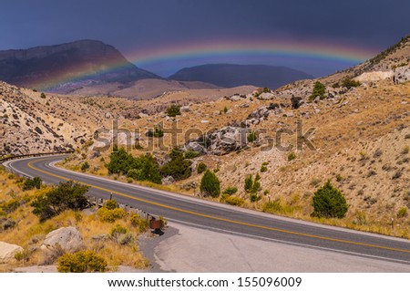 Rainbow over the road leading to Bighorn National Forest