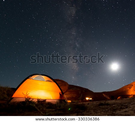 Beautiful Nigt Sky with Milky Way small tent and a camp fire red canyon