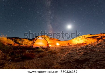 Beautiful Nigt Sky with Milky Way small tent and a camp fire red canyon