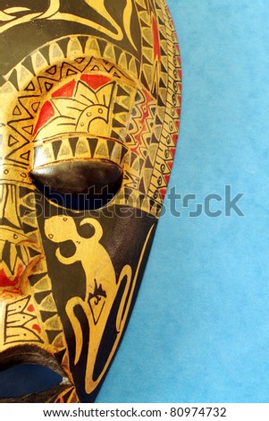 Side of African Decorative Mask With Blue Background