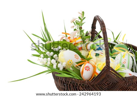 Basket full of easter eggs and spring flower