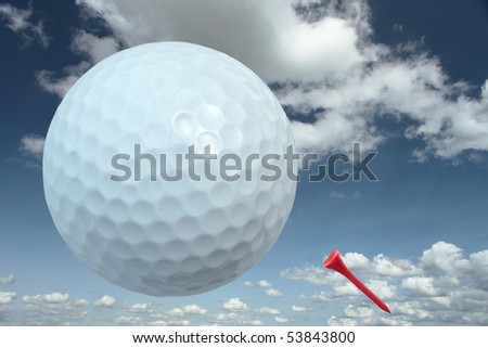 golf ball with red tee and cloudy blue sky