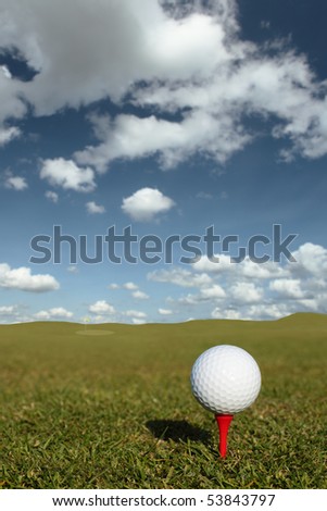 Golf ball on red tee with selective focus picking pick the ball
