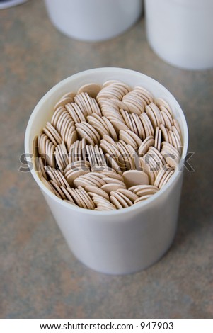 A container of tongue depressors in a doctor\'s office.