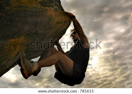 Rock climber reaching for the sky.
