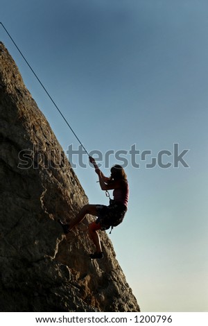 A woman climbs a cliff in California