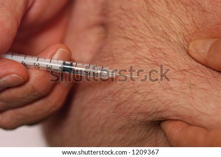 Diabetic man shoots insulin (needle point focus)