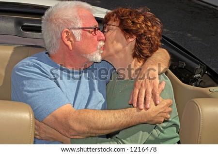 Couple kissing in back seat of car