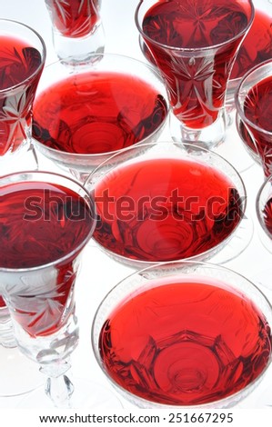 Alcoholic liquors in the crystal glasses isolated on white background