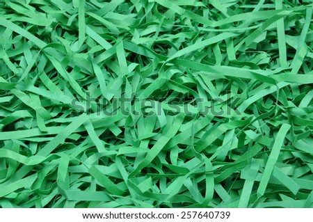 Green shredded paper as background, packaging material