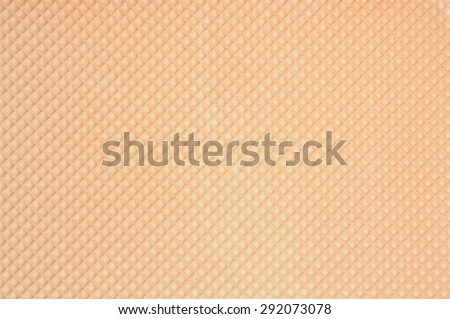 Golden waffle background with regular grid pattern