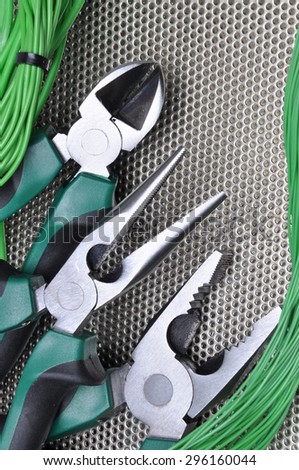 Electrical tools and cables on metal surface