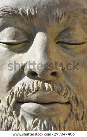 Man\'s face sculpture in bronze