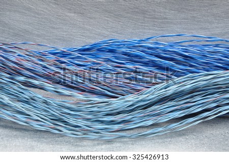 Colored cables and wires on metal background with place for text