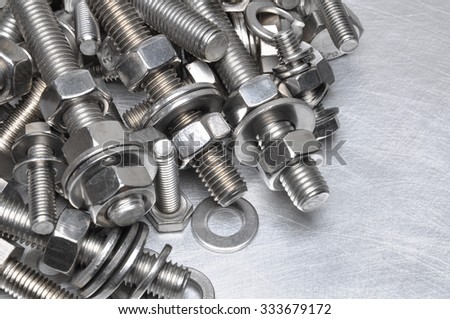 Bolts and nuts on grey metal background