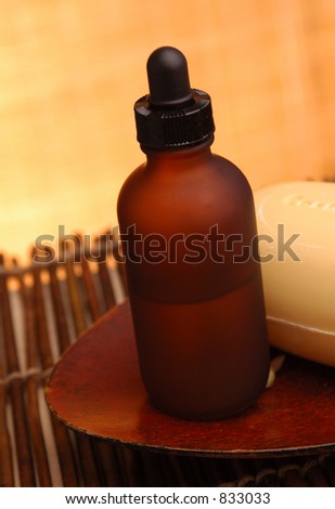 Amber bottle and soap on bamboo