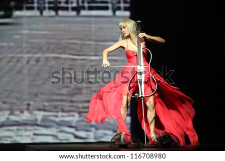 ZAGREB, CROATIA - OCTOBER 18: Ana Rucner playing cello and wearing dress made by Elfs on \'Croaporter\' fashion show, on October 18, 2012 in Zagreb, Croatia.