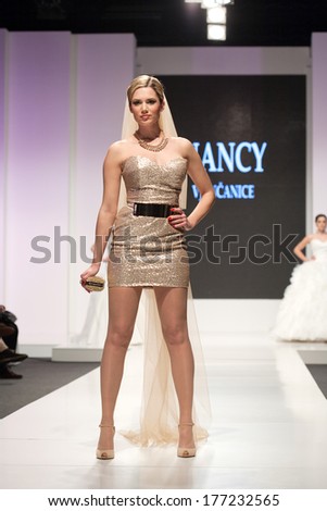 ZAGREB, CROATIA - FEBRUARY 15, 2014: Fashion model in golden wedding dress on \'Wedding days\' show