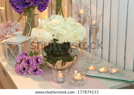 Table Decorated With Candles And White Roses