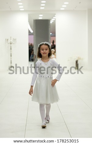 ZAGREB, CROATIA - FEBRUARY 22, 2014: Little girl in bridesmaid dress on \'Wedding expo\' show