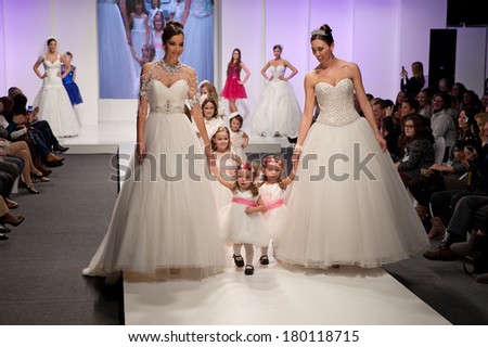 ZAGREB, CROATIA - FEBRUARY 15, 2014: Fashion models in wedding dresses with children models dressed as little bridesmaid on 'Wedding fair'