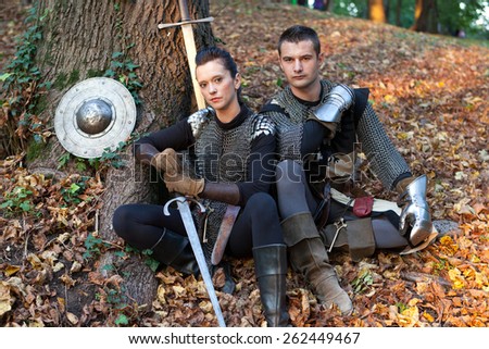 ZAGREB, CROATIA - OCTOBER 07, 2012: Woman and a man dressed in medieval clothes with swords, posing after the \