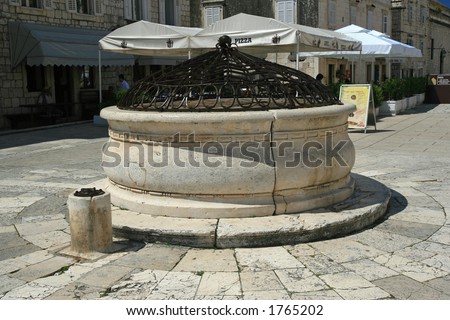 Ancient stone well in the main square in Hvar, Croatia
