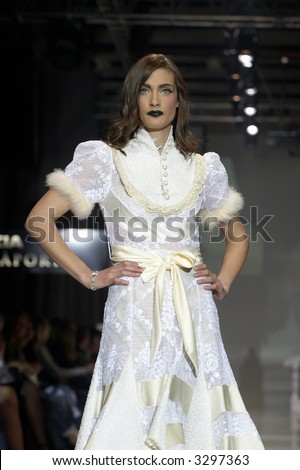 Fashion model in white dress with golden belt