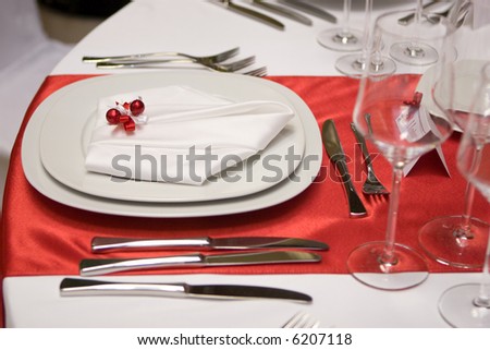 stock photo Table setting with a plate and a napkin in red and white