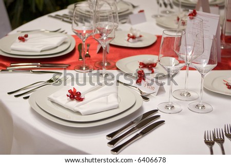 stock photo Table setting with plates and silverware in red and white 