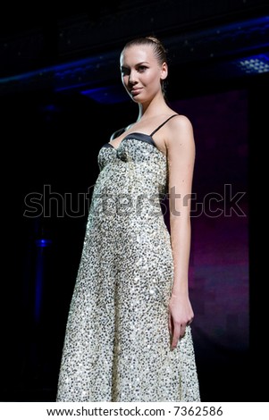 Fashion model in a sparkling dress posing