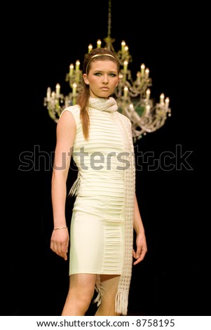 Fashion model in white knitted dress