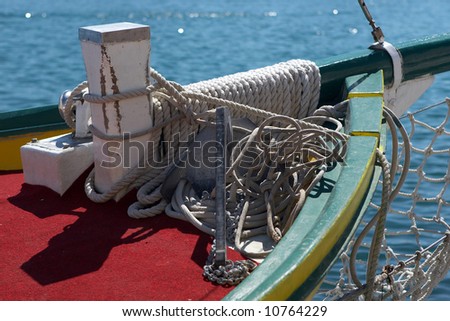 Collection of ropes and anchor on an old wooden sail boat