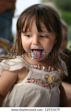 Cute little girl eating cake