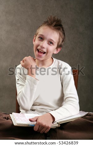 Boy with spiky hair reading a book