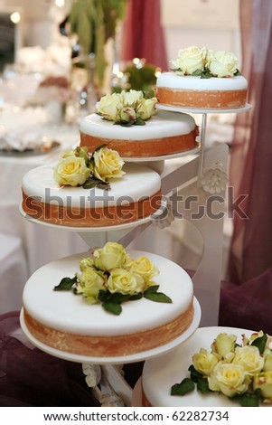stock photo Beautiful wedding cake decorated with yellow roses