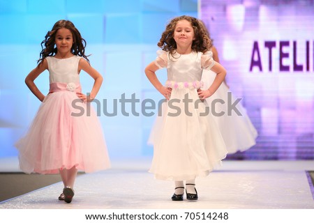 ZAGREB, CROATIA - FEBRUARY 4: Unidentified children Fashion model in bridesmaid dresses on \'Wedding days\' show, February 4, 2011 in Zagreb, Croatia.